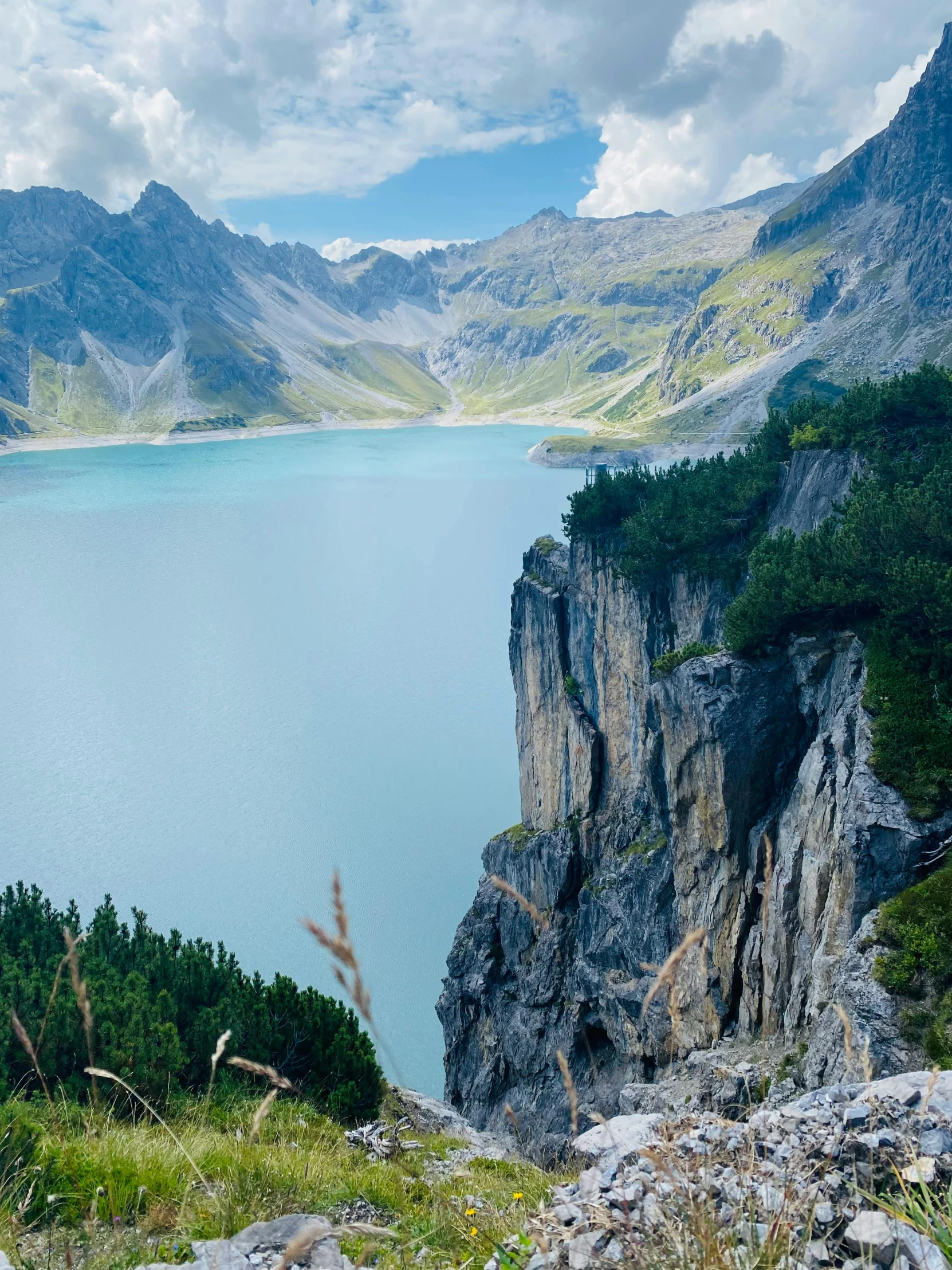 a lake surrounded by mountain ranges is shown