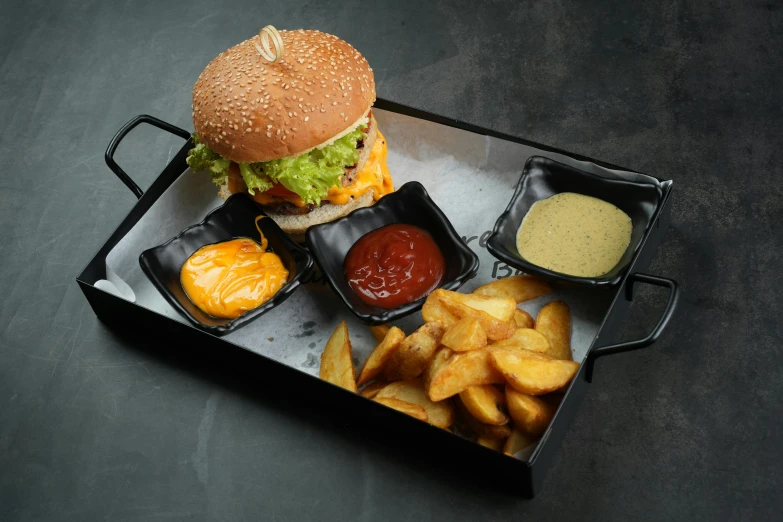 a tray full of fries, salad and a burger