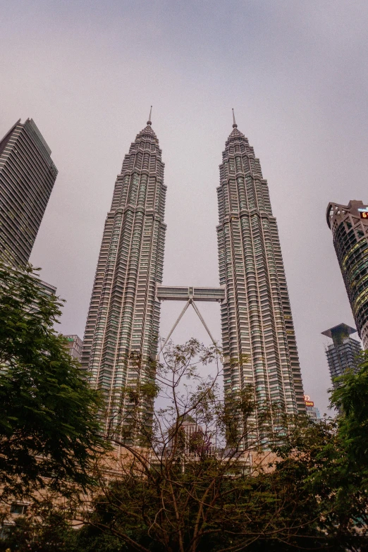 a view from the ground looking up into the sky of some tall buildings