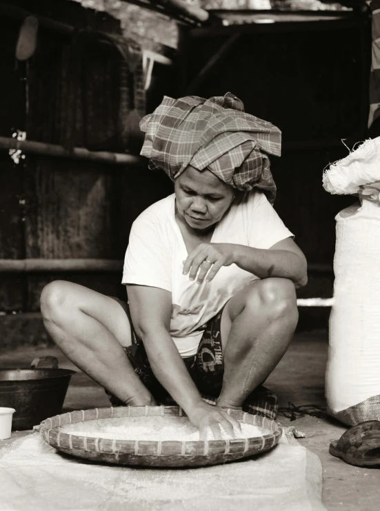 a young person sits in the floor near a bag