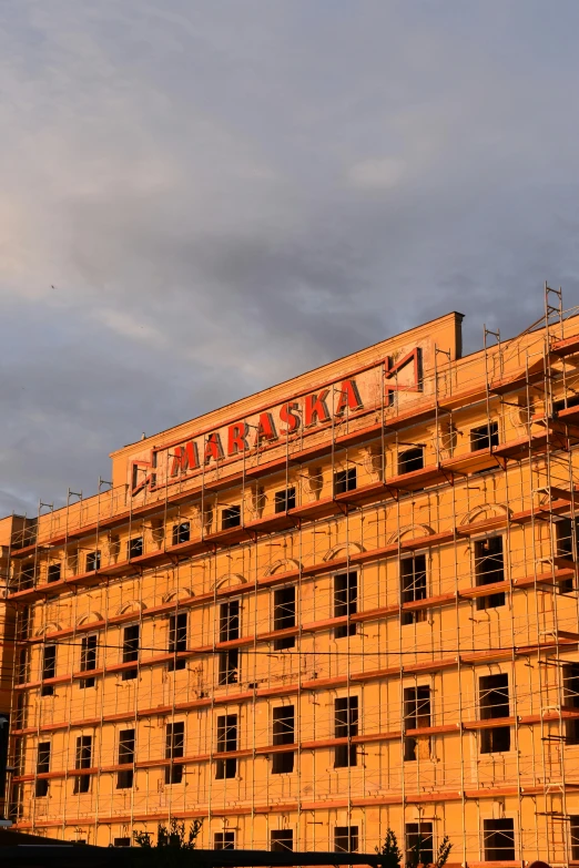 an old building with scaffolding that is very yellow