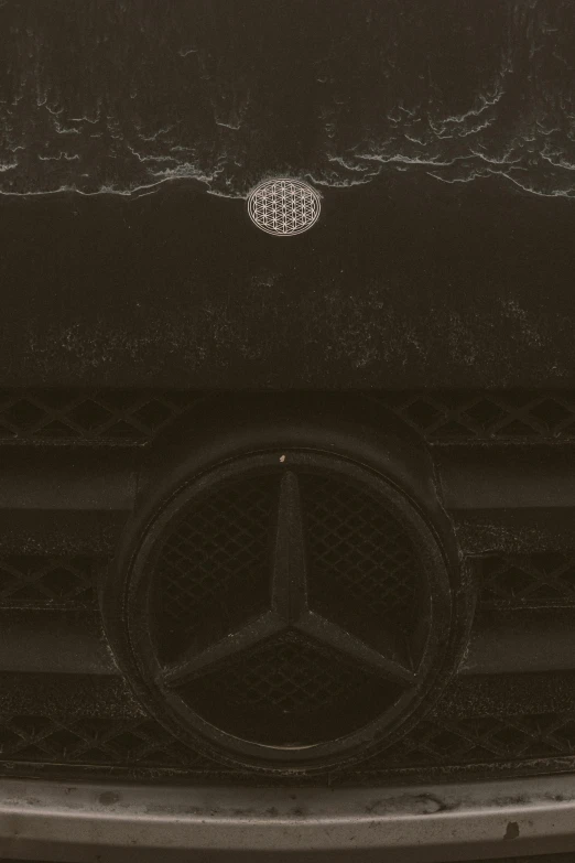 close up of mercedes emblem on shiny metal