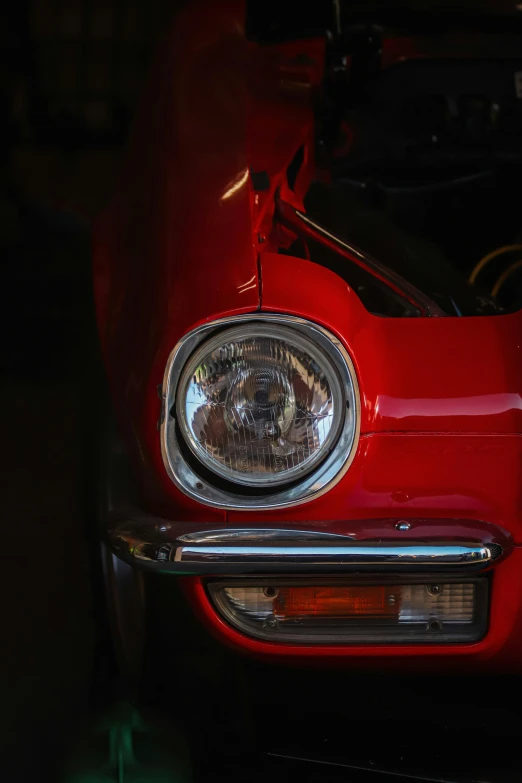 the front of a red classic sports car