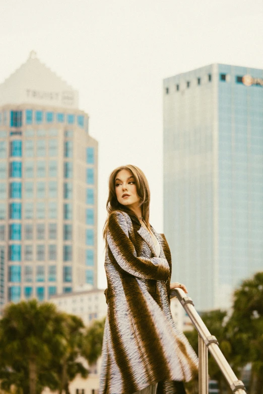 a girl standing by a set of steps wearing boots and a long furry coat