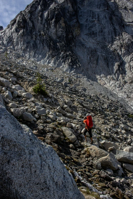 a hiker in the mountains near large rocks