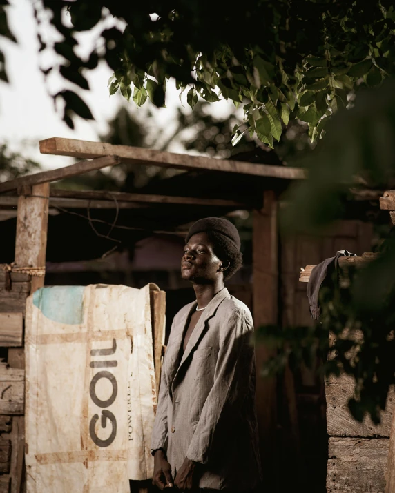 a man holding a piece of wood outside