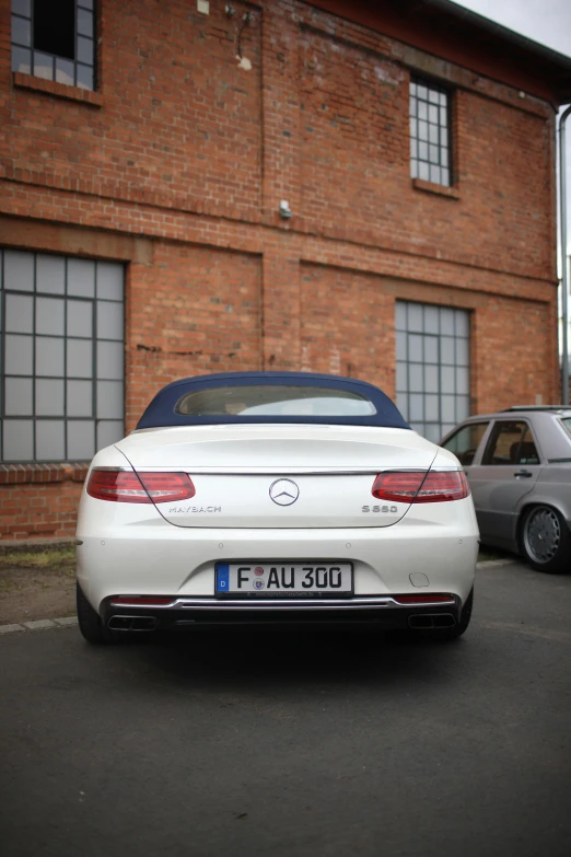 the rear end of a white car and a silver car