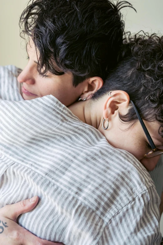 a woman hugging a baby on top of her back