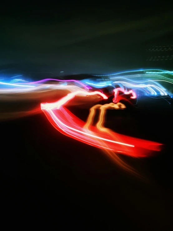 neon lights create an abstract painting of a man surfing on a board