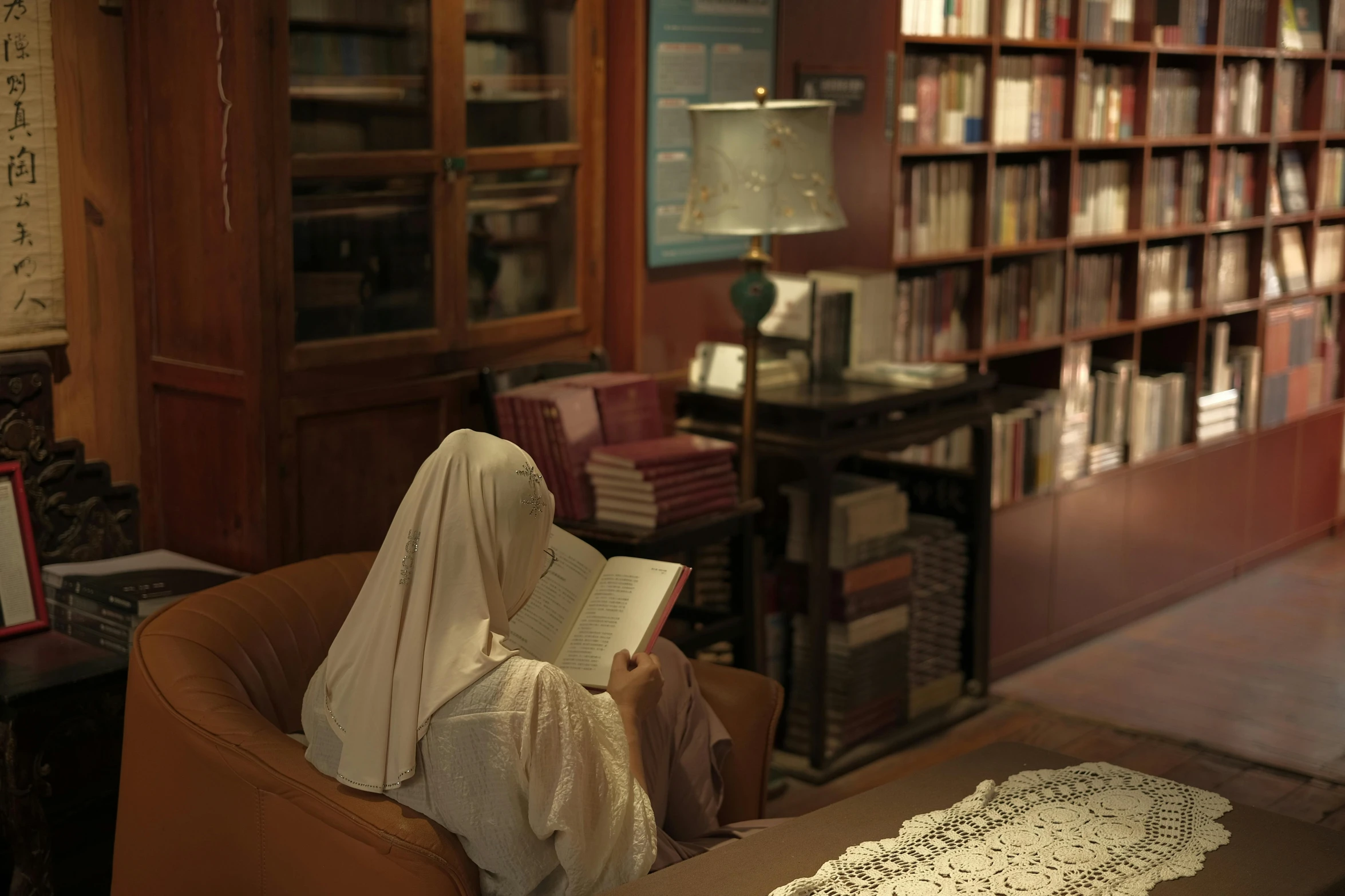 a woman reading in a room filled with books