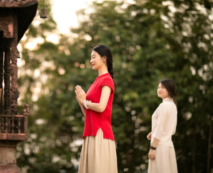 two people dressed in traditional clothing standing beside each other