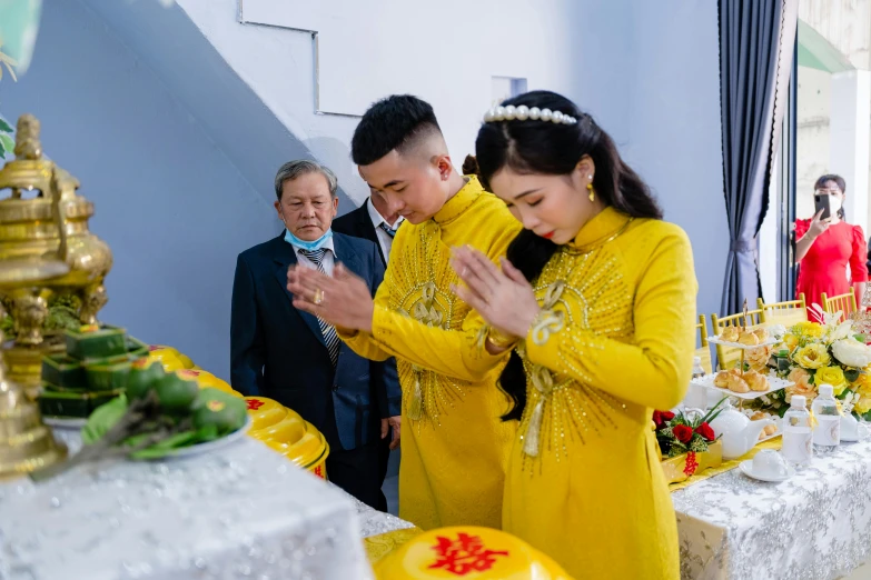 couple standing together in front of a table with food and drinks