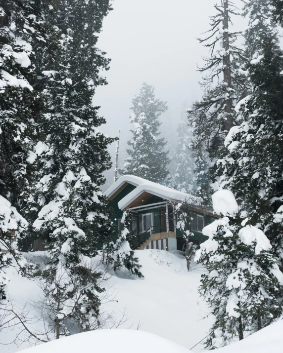 a house on top of a snow covered hill