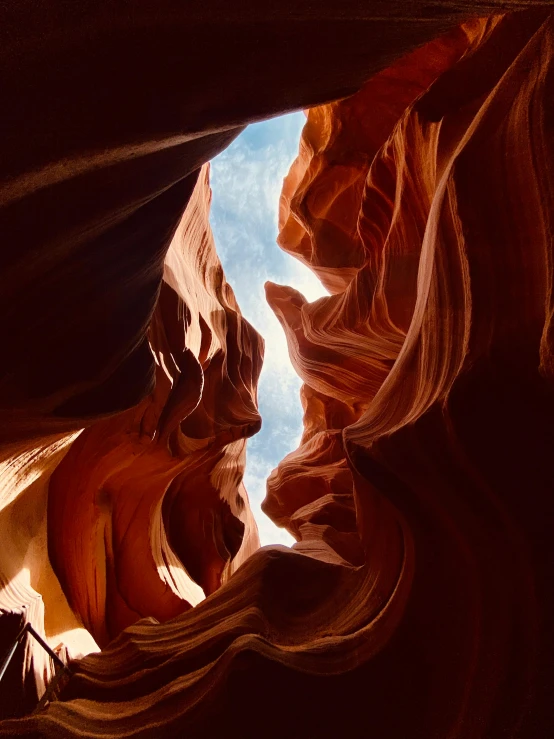 inside the canyon on the far side of the image looking up at the sky