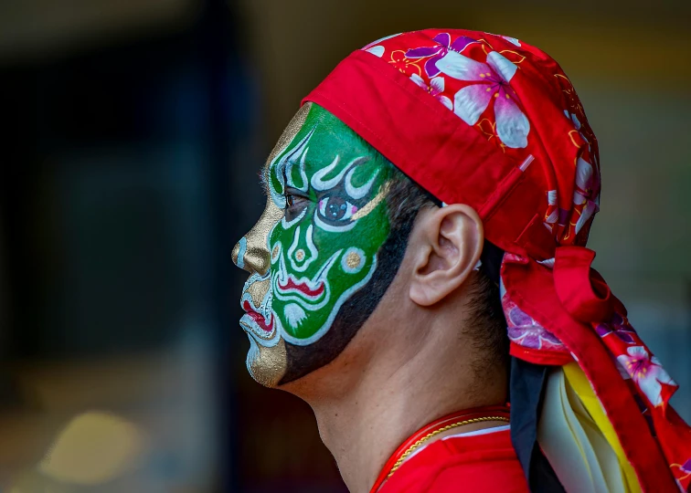 a man with colorful facial decorations painted on his face