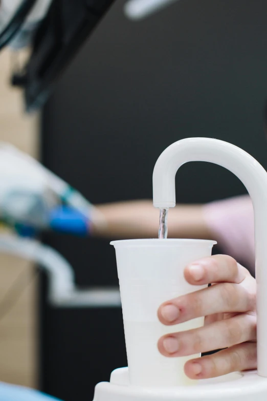 someone holding a cup with water in it