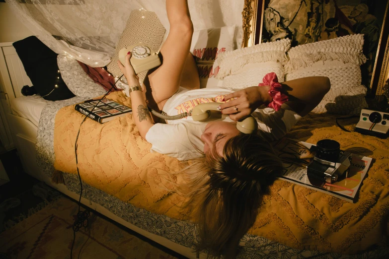 a woman laying on a bed covered in pillows