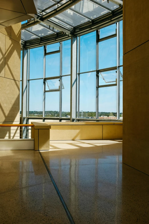 the interior of a large room with large windows and tile floor