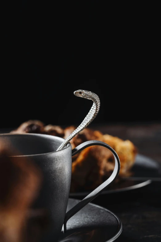 an ornate handle on the fork sits in front of a plate of food