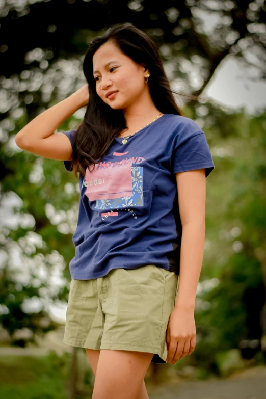 an asian woman standing wearing some shorts