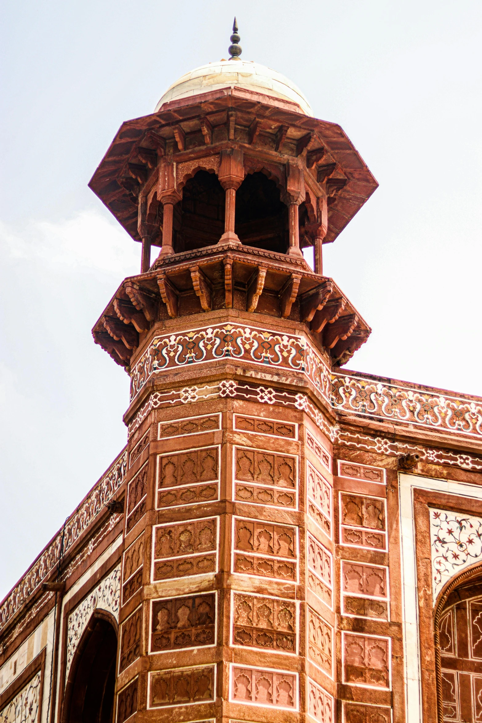 a tall stone structure with an ornate roof