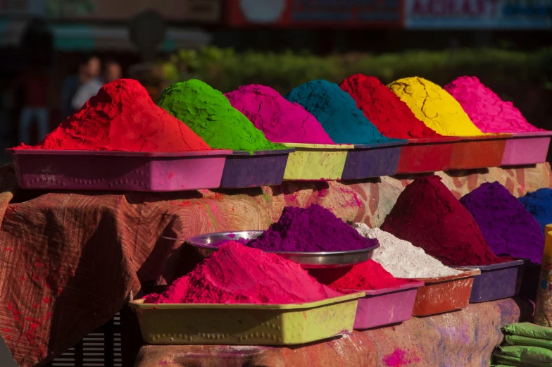 colorful colored powders are on display in front of a table