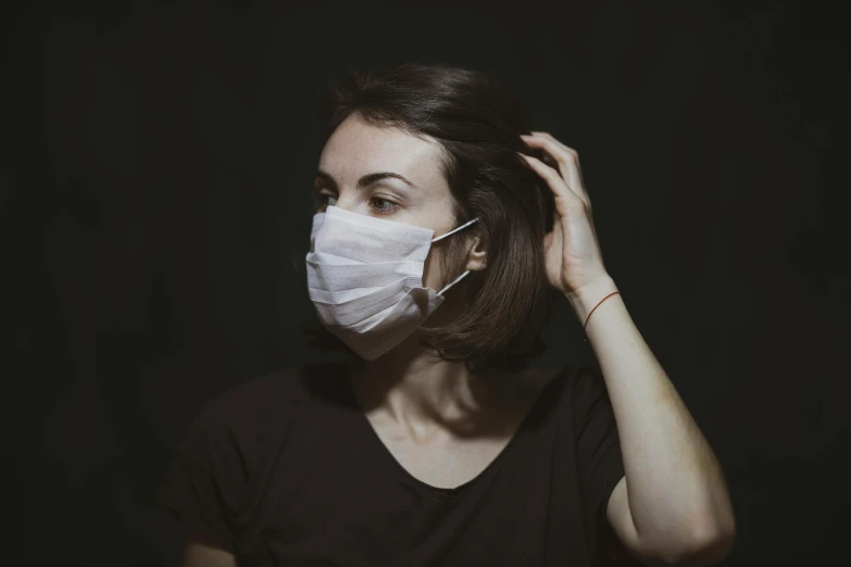 a woman wearing a surgical mask to protect herself from the sun