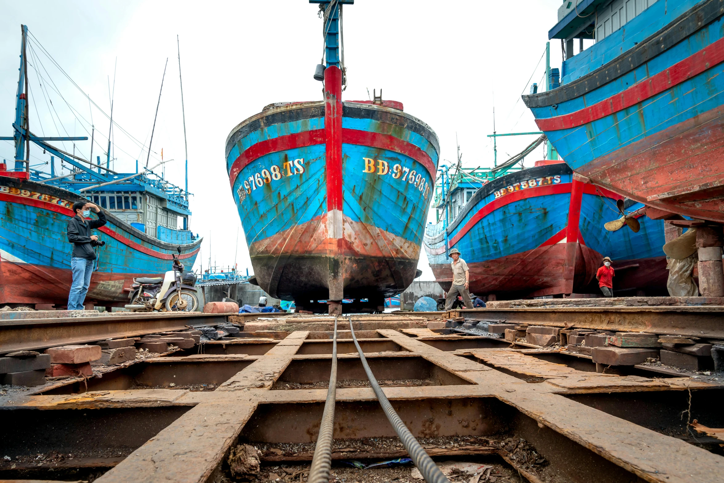 a number of ships with one large and one small on the beach