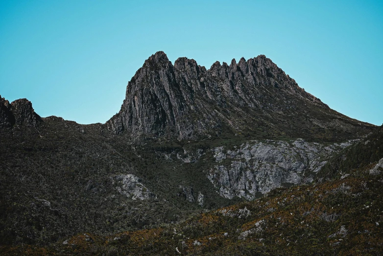 a mountain view taken from below during a sunny day