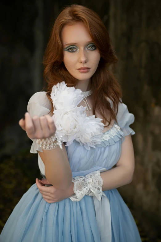 a young woman with blue eyes posing in her dress