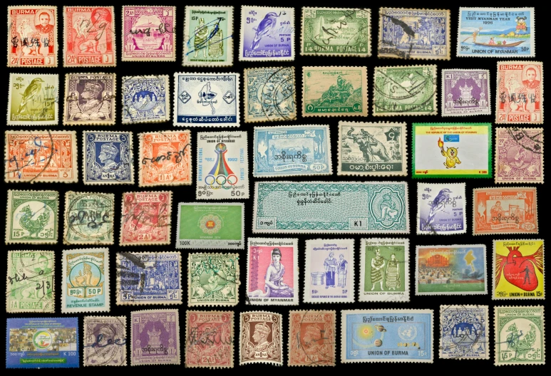 a group of postage stamps on display next to a black background
