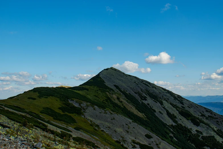 a very tall mountain sitting under a blue sky