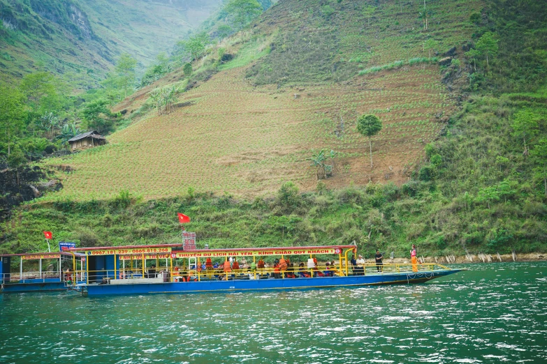 blue long boat with open door going on water