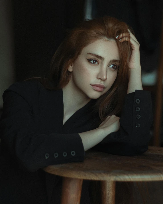 a woman with long hair sitting on a chair