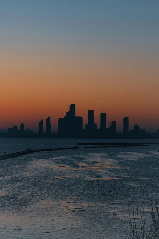 the skyline as seen from a river in a city