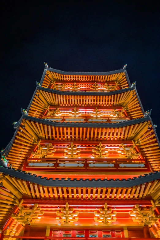 a tall oriental tower lit up at night