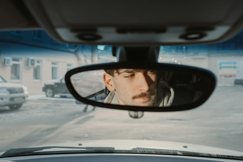 a person in a car while looking out the window