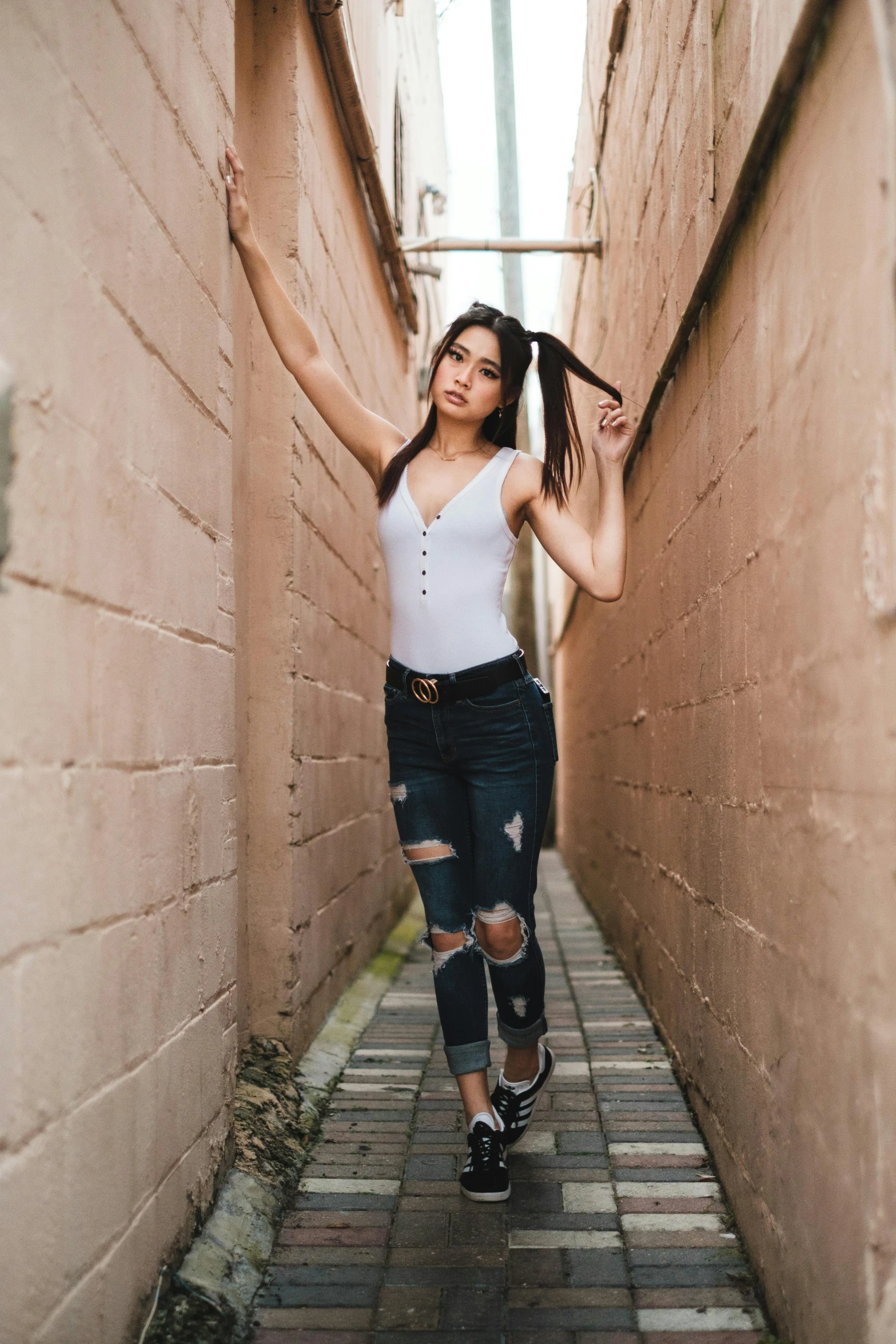 a woman standing between two walls while looking down at soing