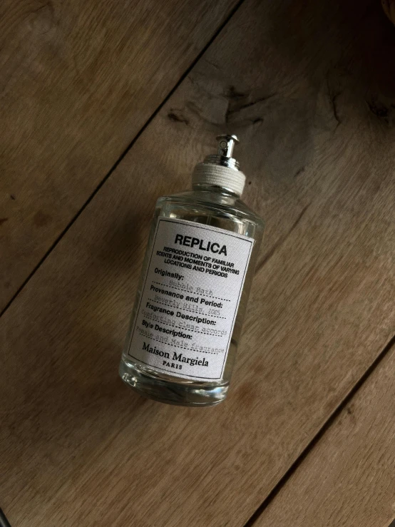 a bottle of liquid on a wooden surface