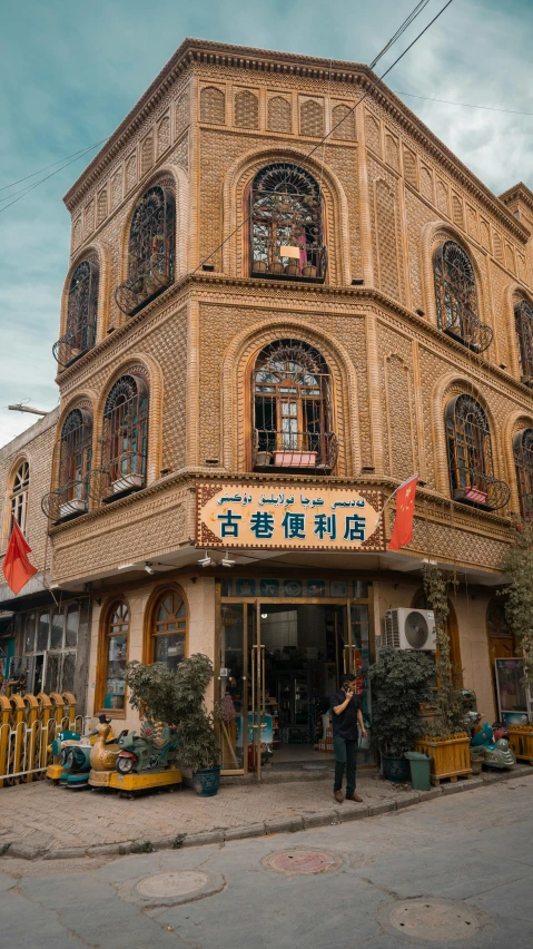 the building has many windows and has people standing outside