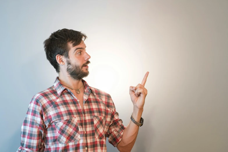 a man is pointing at the light on his left hand