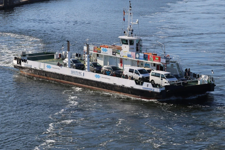 the ferry has several vehicles in the front