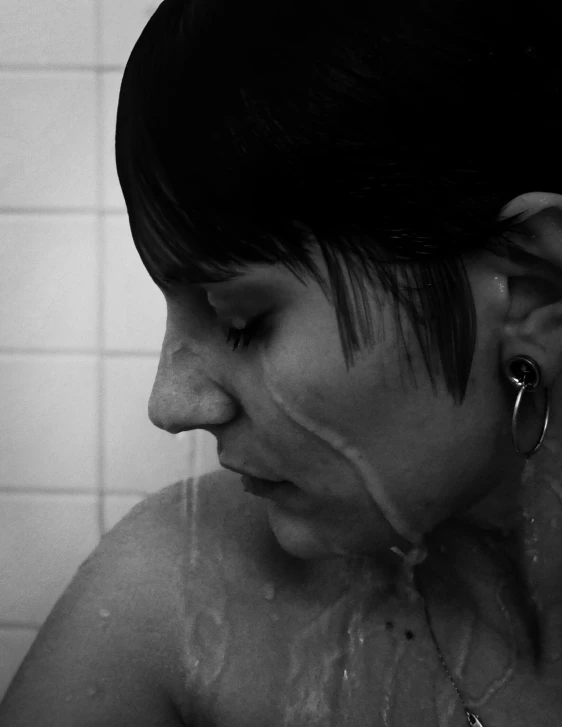 a women with hair up in the shower