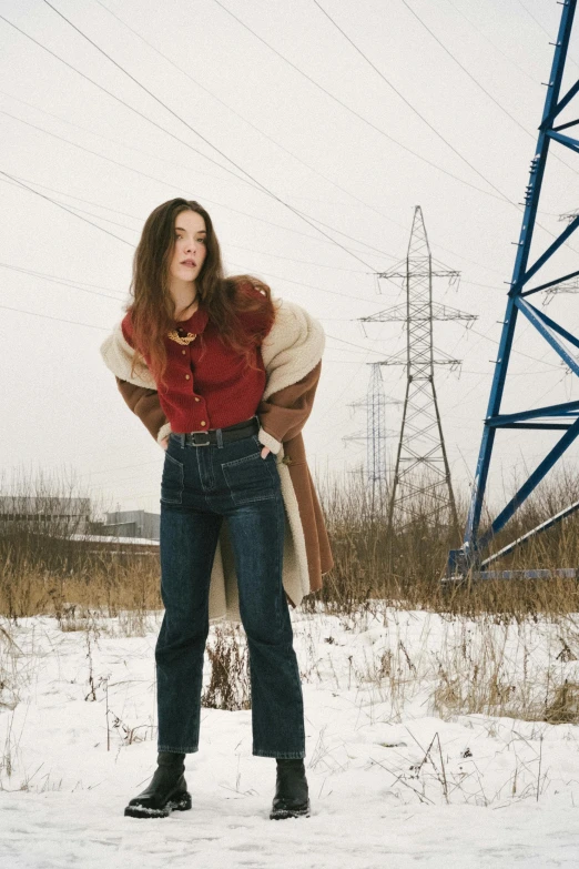 a beautiful woman in a red top and jean pants