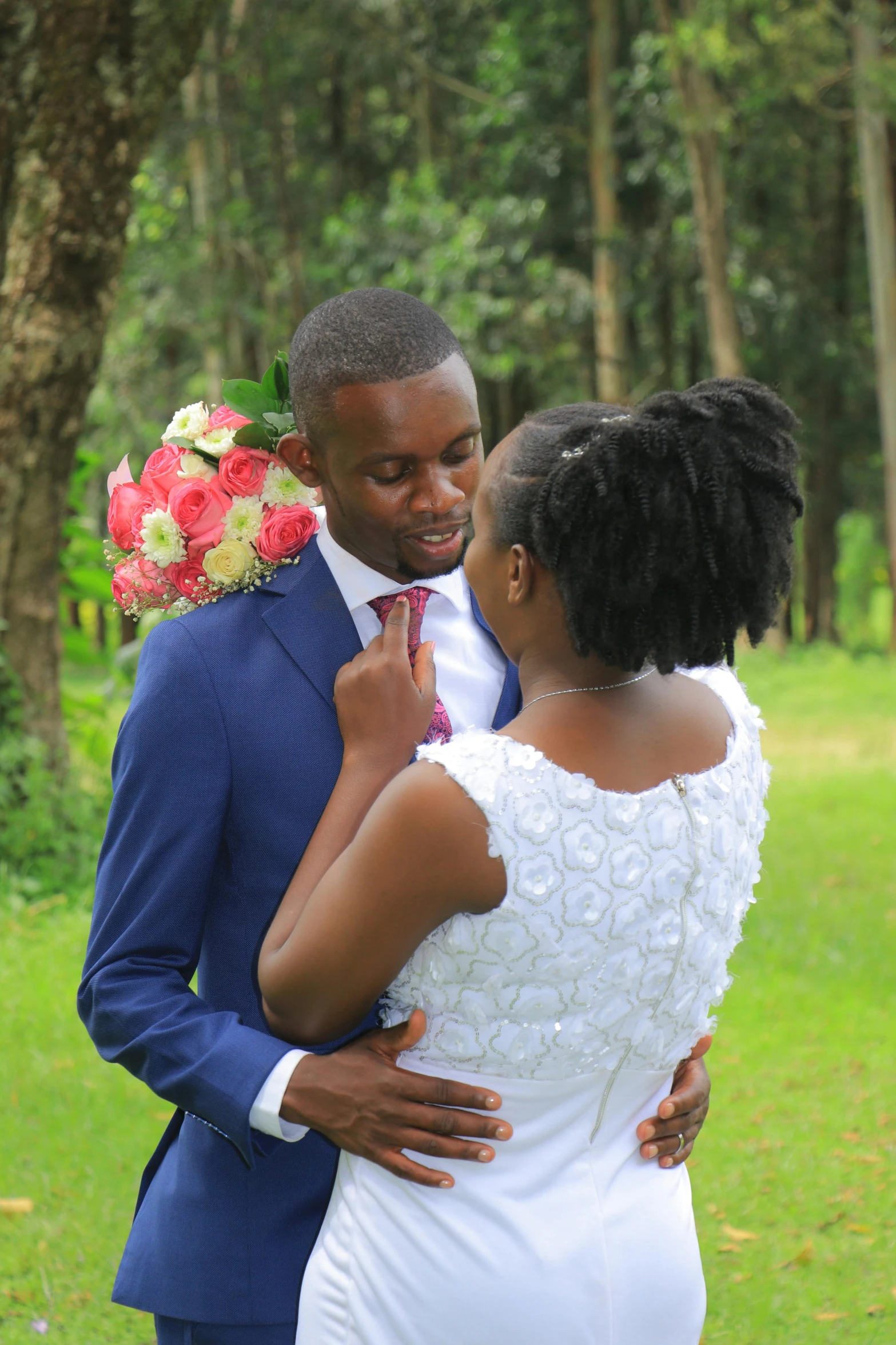 a black bride emcing her groom in the woods