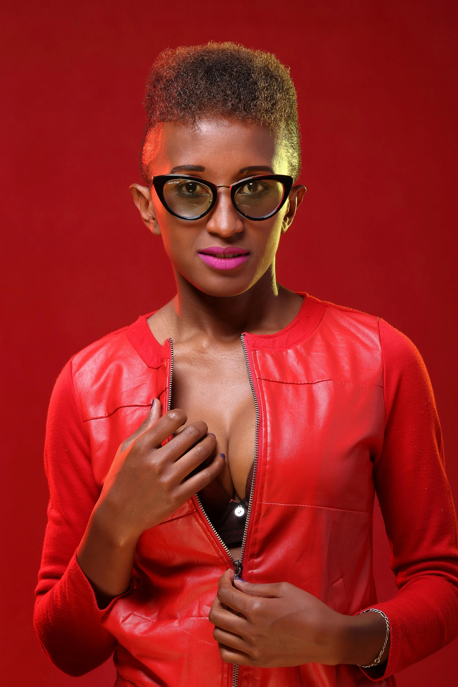 a woman in glasses with red background