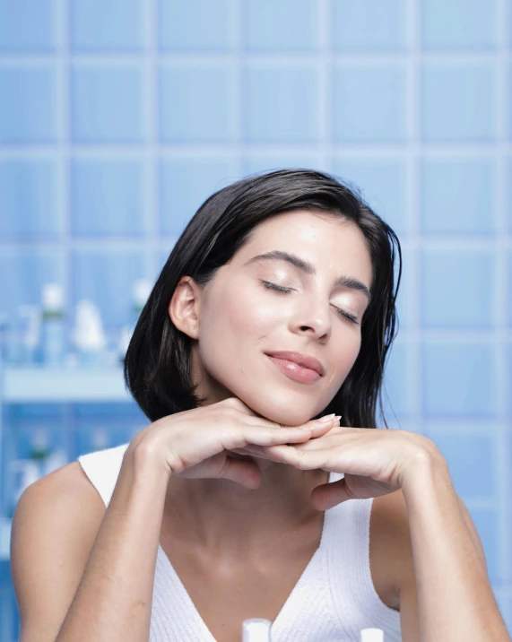 woman holding up her hands and gazing at the soap bottle