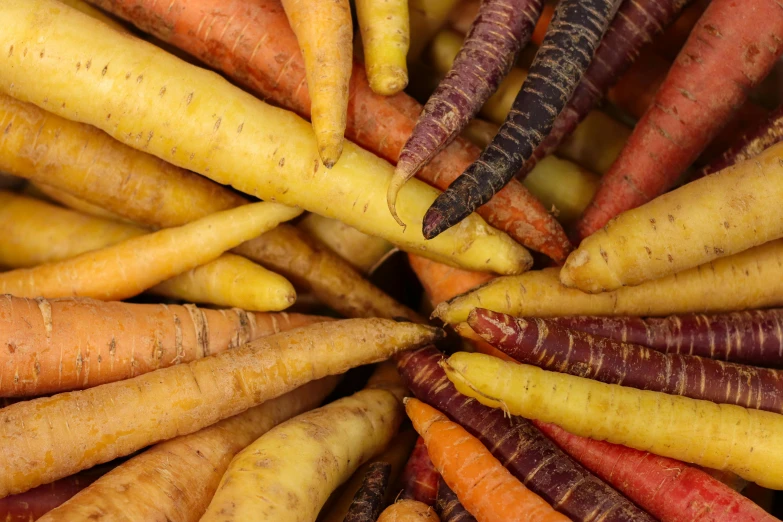 a group of carrots with their tops off in a bowl