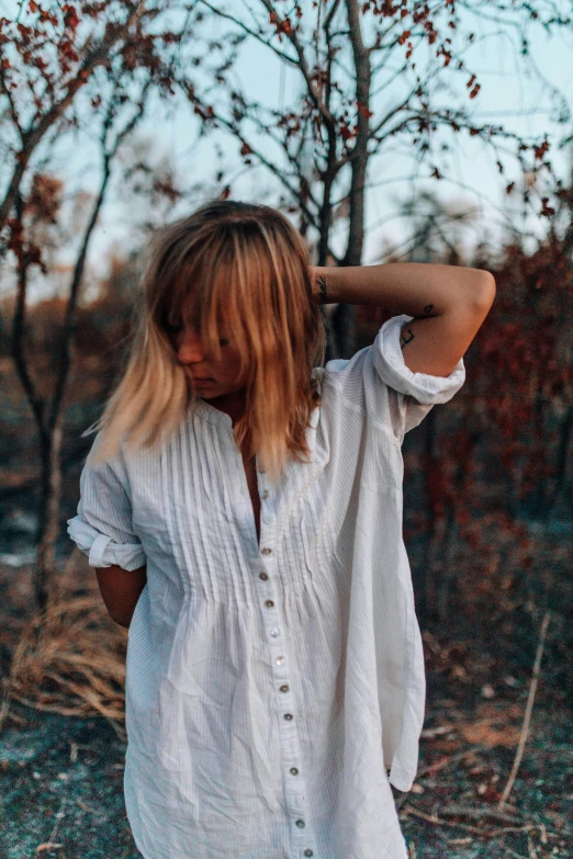 a woman in a white shirt and black pants