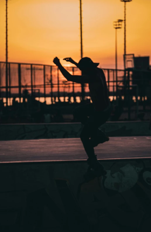 a person is performing skateboard tricks at sunset